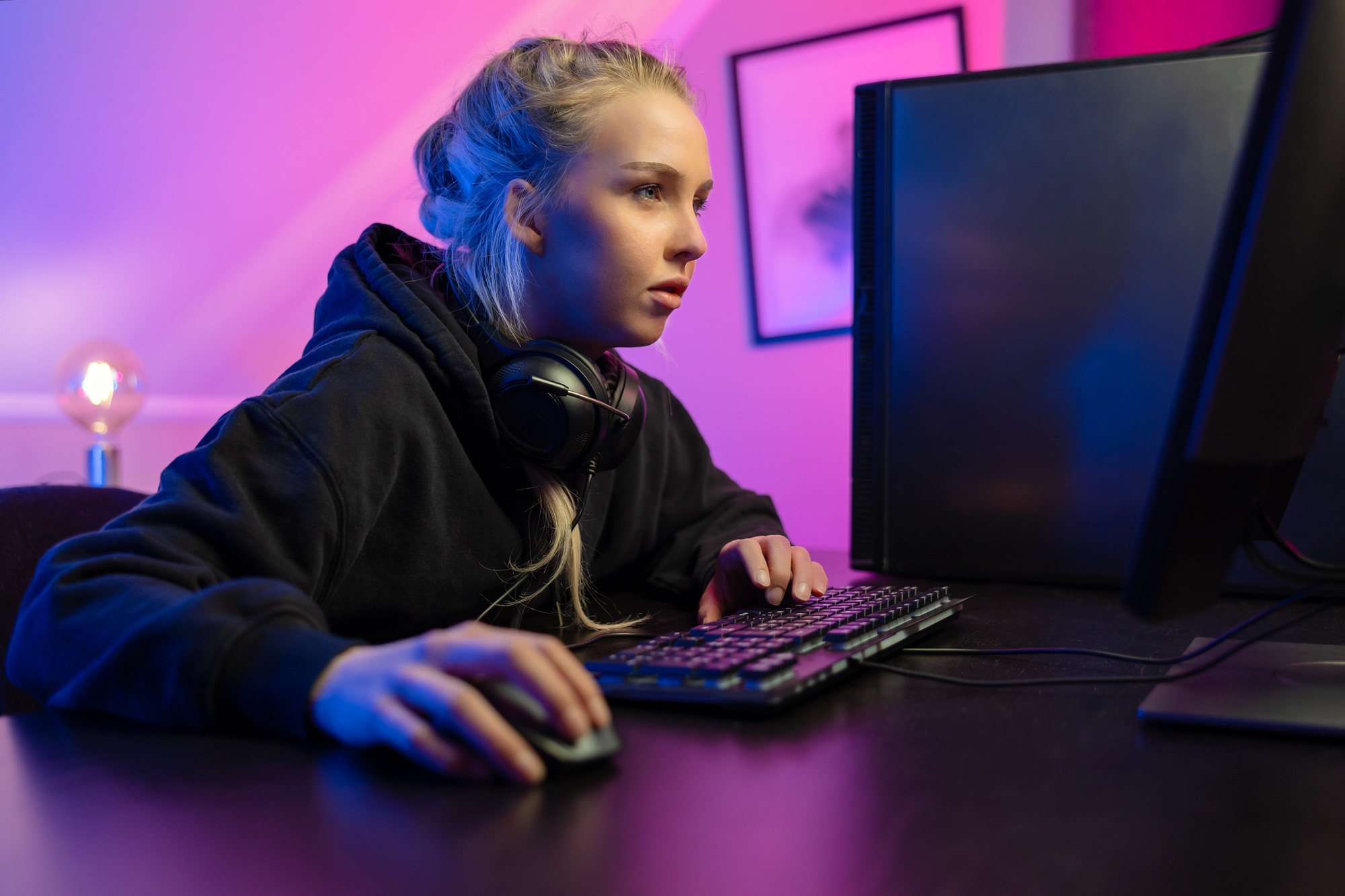 Focused Professional E-sport Gamer Girl Playing Online Video Game on PC