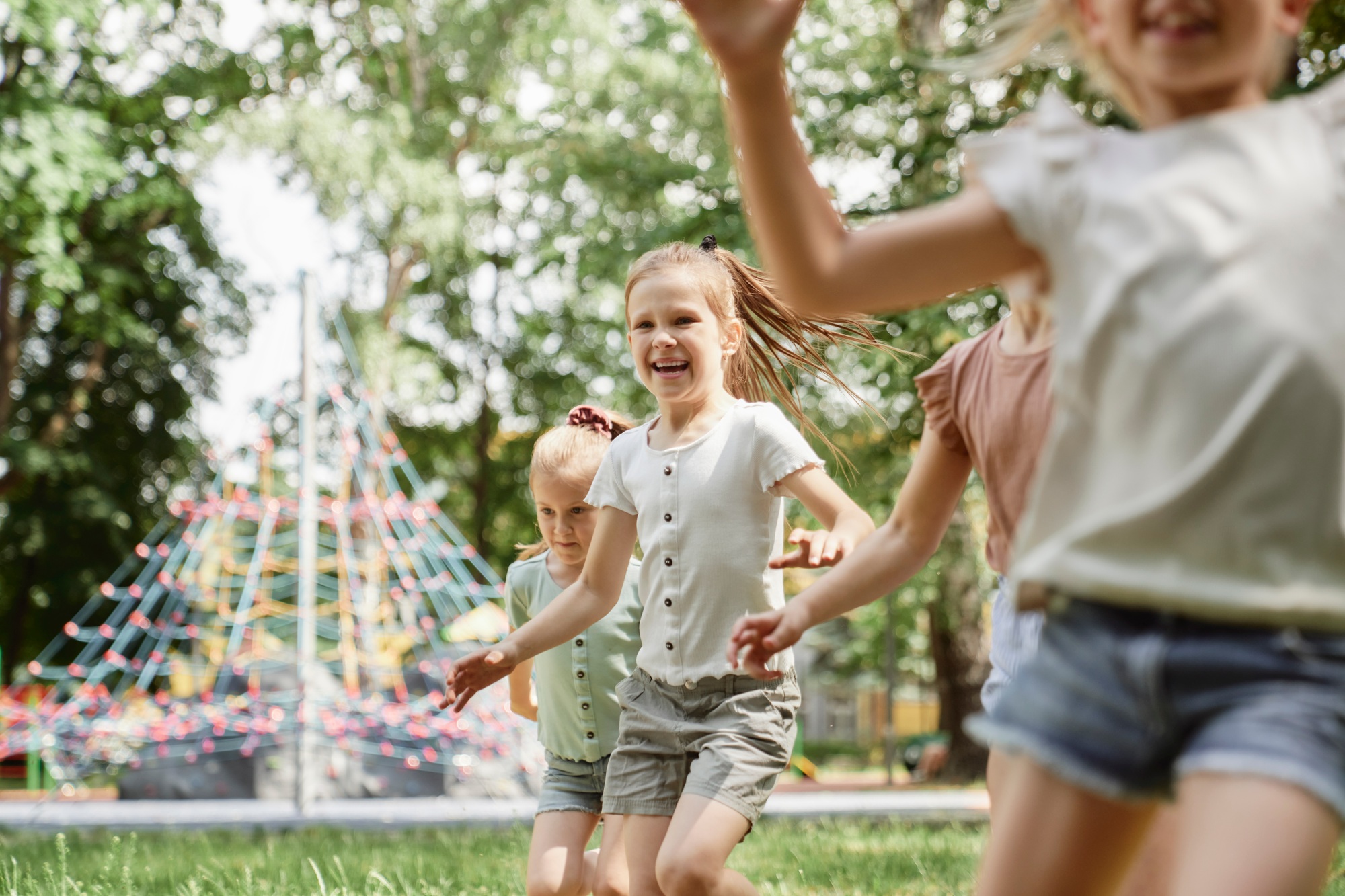 Group of kids playing at the playground in summer day